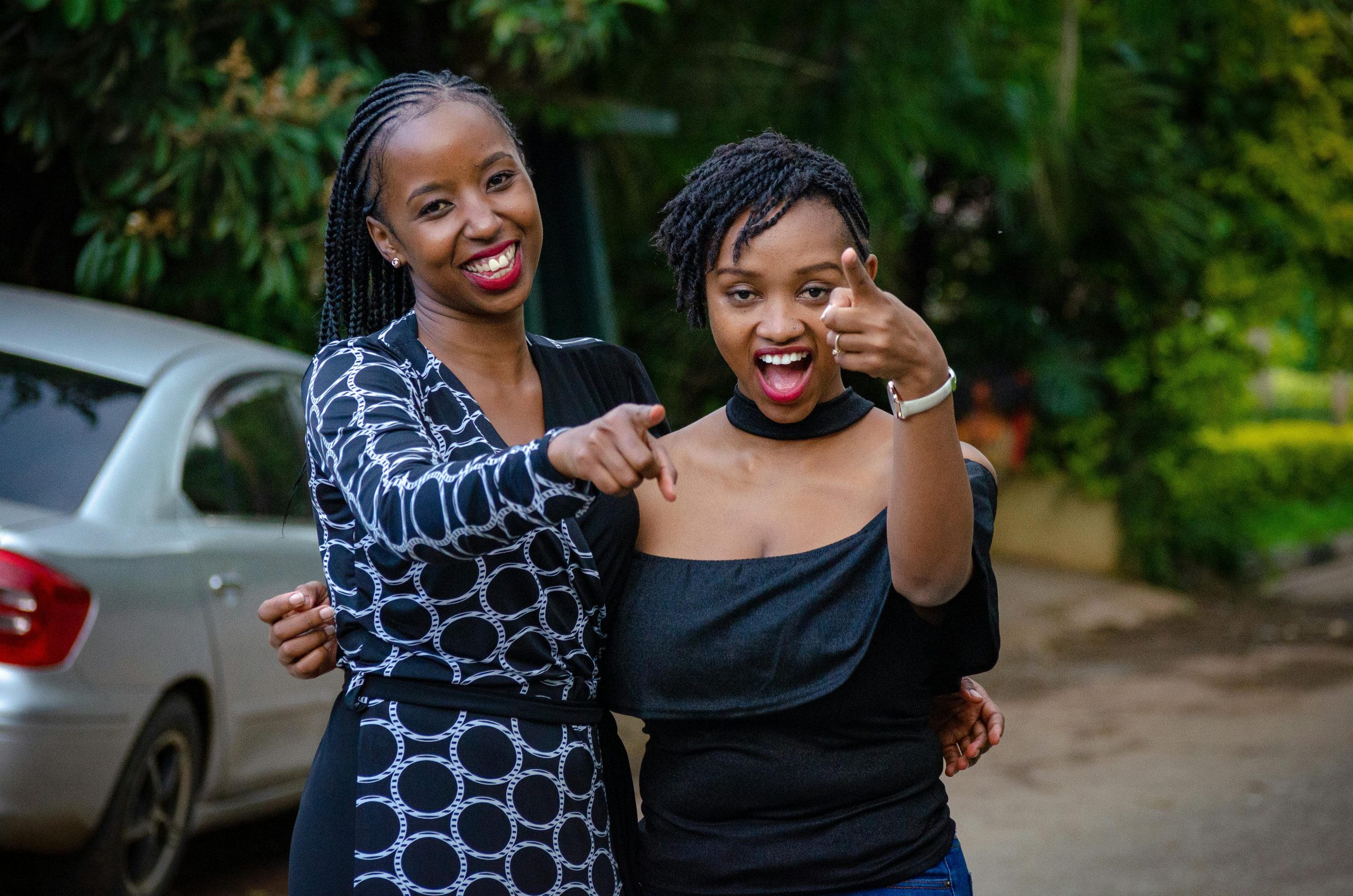 Two friends having fun and laughing outdoors in Nairobi, Kenya. A genuine moment of joy and togetherness.